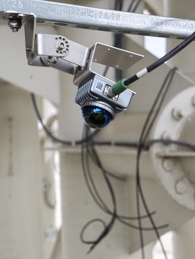 Close-up of a Livox MID-360 dome 3D-LiDAR sensor mounted to a galvanized Würth steel rail on an OWL EYE® TERMINAL drive-through gantry